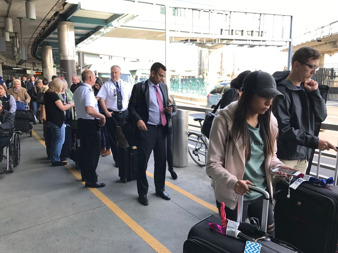 Travelers waiting for taxis outside LaGuardia Airport's Terminal B—there were at least 100 people waiting on April 4, 2017<br>